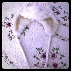 Cable beanie with braided cords and pom poms